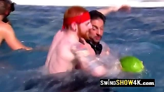 A powered group of swingers is having fun carrying-on naked in the water.